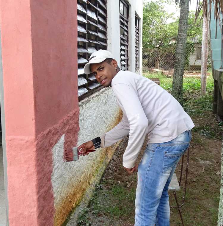 Joven Instructor de arte en labores de pintura.